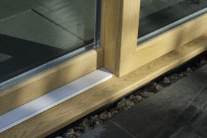 Bottom railing of woodgrain foil patio doors
