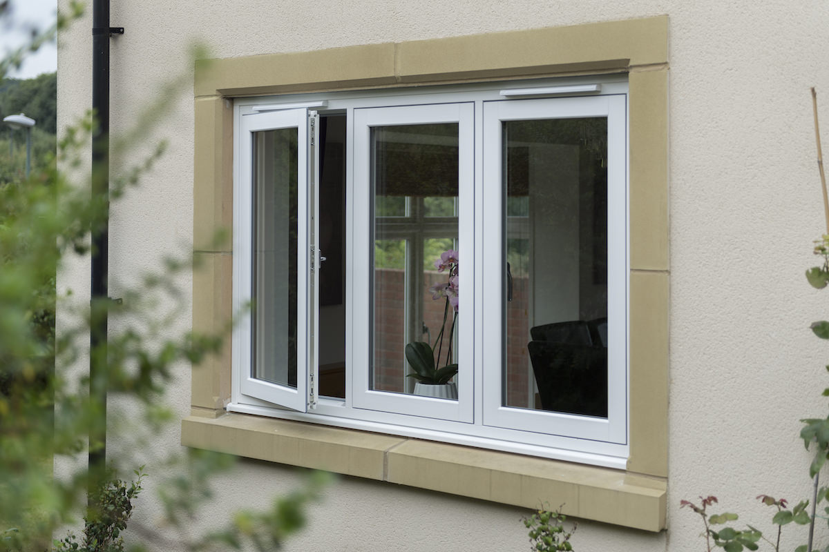 white uPVC flush sash windows with one open on a beige walled home