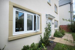 uPVC white flush casement windows from Deceuninck on a beige wall outside